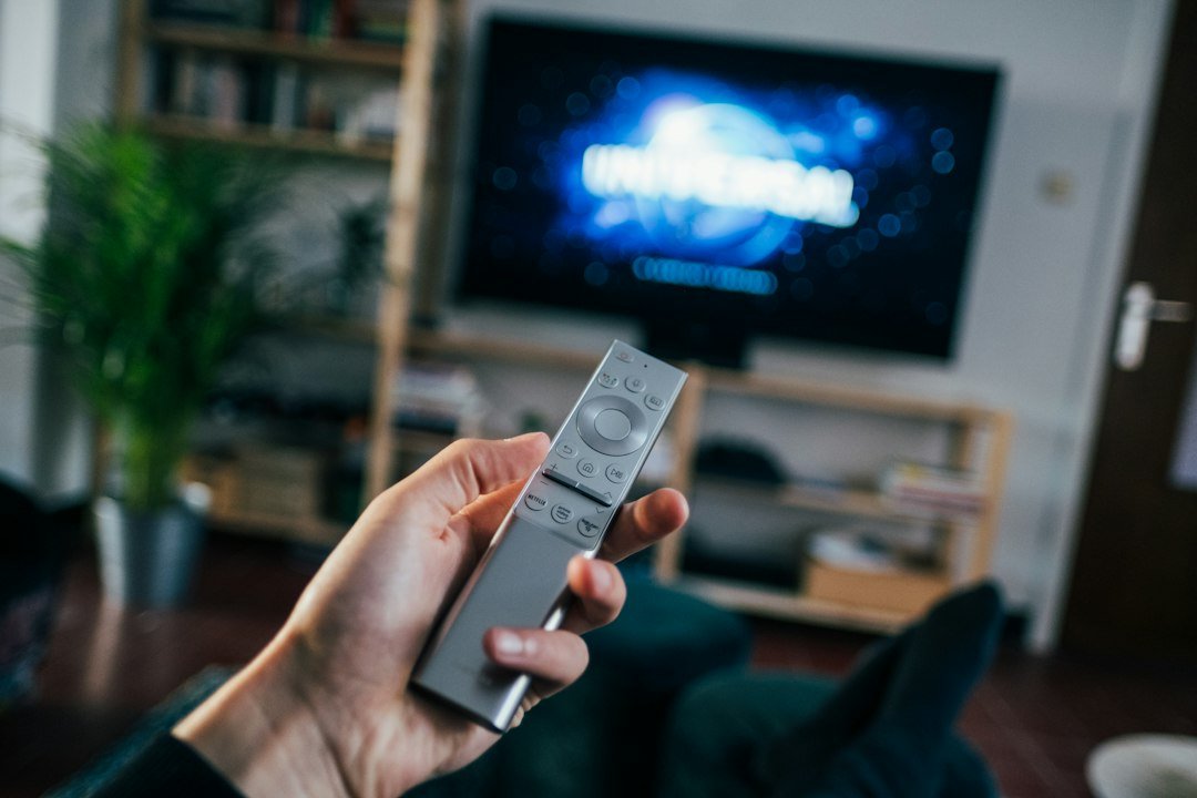 IPTV service on a living room TV showing live channels and a TV guide